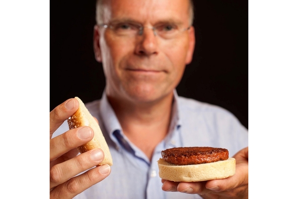 Dr. Mark Post holds a cultivated meat burger.